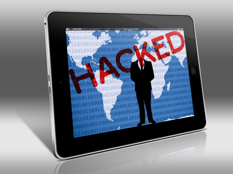 Tablet with 'Hacked' spelled out in red letters across the screen